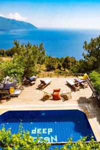 a swimming pool with a view of the ocean at Deep Ocean Camping-Adults Only in Faralya