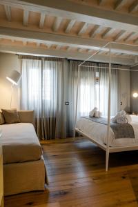 a bedroom with two beds and a canopy bed at Anima di Vinci in Vinci