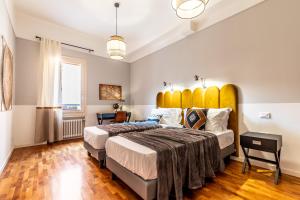 a bedroom with a large bed with a large yellow headboard at HouSmart Capo di Lucca 1 in Bologna