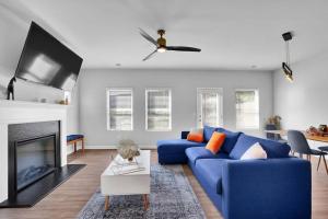 a living room with a blue couch and a fireplace at GoodLiving Atlanta - Family Getaway - Pets Welcome in Atlanta