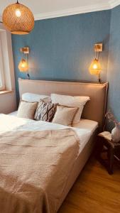 a bedroom with a large bed and a blue wall at Ostseeglück in Zingst