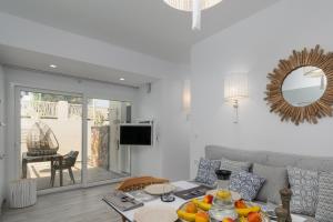 a living room with a couch and a table at Orama Suites Milos in Adamantas