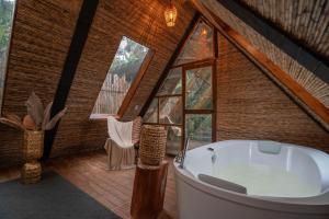 ein Badezimmer mit einer großen Badewanne in einem Baumhaus in der Unterkunft BubbleSky Glamping Guatapé in Guatapé