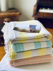 four towels stacked on top of each other on a table at Spacious, seaside, Victorian home "Bay View Terrace", Penzance in Penzance