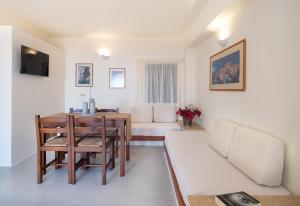 a living room with a table and a couch at Kalimera Village in Hersonissos