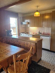 a kitchen with a wooden counter and a wooden table at La Crettaz SUNNY & QUIET apartment 6 pers by Alpvision Résidences in Veysonnaz