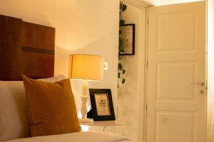 a bedroom with a bed and a lamp on a table at Panorama Guest House in Alghero