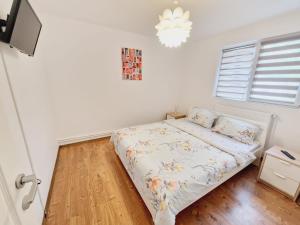 a bedroom with a bed and a chandelier at DREAM Apartment in Sinaia