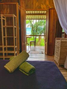 a bedroom with a bed with two pillows on it at Casas D'Água Doce - Casa Amora in Ilhabela +54 photos
