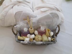 a basket filled with different items on a bed at Villa Margherita Suite & charme in Pula