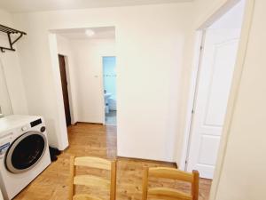 a kitchen with two chairs and a washing machine at DREAM Apartment in Sinaia