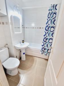 a bathroom with a toilet and a sink and a tub at DREAM Apartment in Sinaia