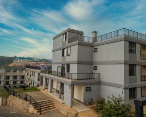 an apartment building with a balcony on top of it at Phoenix Apartment by LINK in Kigali