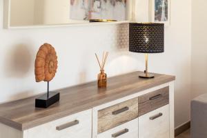 a wooden dresser with two lamps on top of it at Apartamento Sunset on the Sea in Albufeira