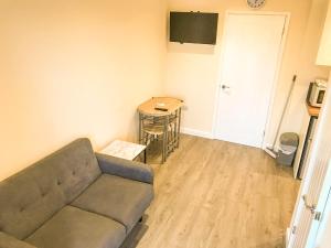 a living room with a couch and a table at Rabbits Warren, 2 Single Bed Holiday Let in The Forest of Dean in Blakeney