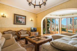 a living room with couches and a coffee table at Villa Cintya - PlusHolidays in Calpe