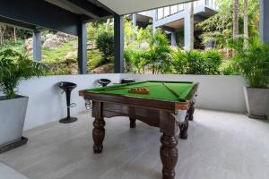 a pool table sitting on top of a patio at paradise sea view infinity Pool Villa Chaweng Koh Samui in Chaweng Noi Beach