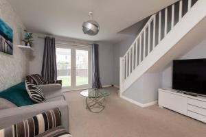 a living room with a couch and a tv at Spenny View in Spennymoor