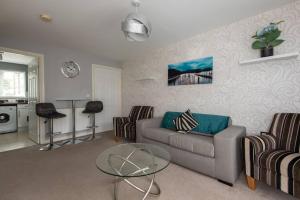a living room with a couch and chairs and a table at Spenny View in Spennymoor