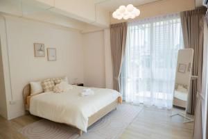 Postel nebo postele na pokoji v ubytování 2BR minimal mu-ji style 130SQM ~