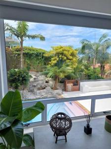 a view of a garden from a large window at Harbour View House in Durban