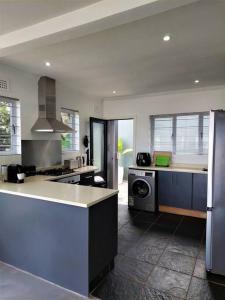 a kitchen with a sink and a stove top oven at Harbour View House in Durban