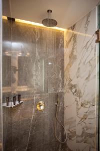 a bathroom with a shower with a glass door at Villa Mediterrane Hotel in Iraklitsa +81 photos