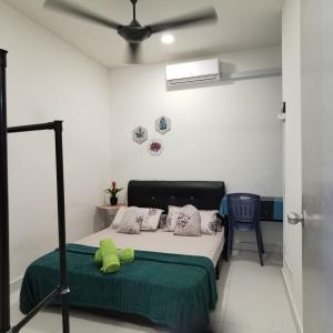 a bedroom with a bed with a teddy bear on it at IMAN HOMESTAY : PRIMA HOMES MATANG APARTMENT in Kampung Gita