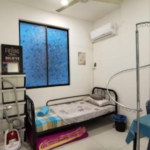 a hospital room with a bed and a window at IMAN HOMESTAY : PRIMA HOMES MATANG APARTMENT in Kampung Gita