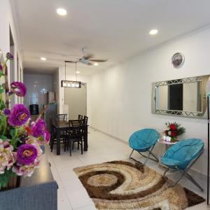 a living room with a rug on the floor at IMAN HOMESTAY : PRIMA HOMES MATANG APARTMENT in Kampung Gita