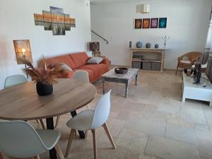 a living room with a table and a couch at Domaine Les Grenadiers de Saint Sat in Saint-Saturnin-lès-Apt