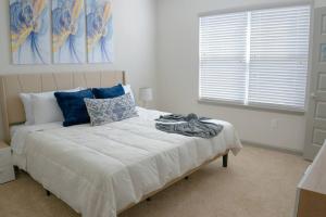 a bedroom with a large bed with blue pillows at Modern and Spacious King Size Retreat in Concord