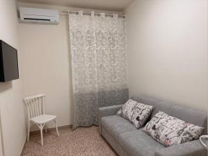 a living room with a couch and a chair at Casetta sul Mare in Fano