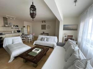 a living room with two couches and a table at MY OCEAN HOME - Breathtaking location, Steps to the ocean, Spacious sea view, Fully Equipped and Well-Furnished with Private Entrance and High-Speed Fiber Optic Internet in Corralejo