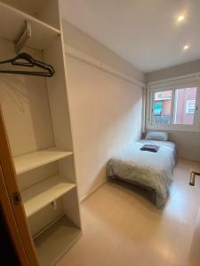 a bedroom with a bed and a book shelf at Cozy apartment at a great location! in Hospitalet de Llobregat