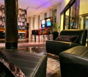 a lobby with couches and a tv in a building at Comfort Hotel Eskilstuna in Eskilstuna