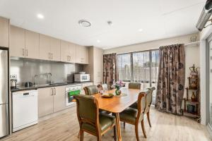 a kitchen and dining room with a table and chairs at Albert Town Bach - Wanaka Holiday Home in Wanaka