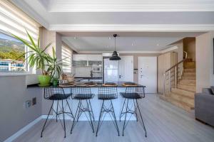 a kitchen with a island with bar stools at Comfort-design-peace of mind in Fethiye