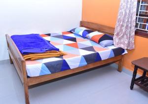 Postel nebo postele na pokoji v ubytování Kaveri Homestay