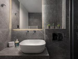 a bathroom with a large white tub in a room at Marita Luxury Apartment with parking space in Chania