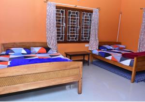 Postel nebo postele na pokoji v ubytování Kaveri Homestay