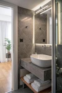 a bathroom with a sink and a mirror at Marita Luxury Apartment with parking space in Chania