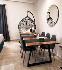 a dining room table with chairs and a mirror at Minimal 3BR Apartment in Athens in Athens