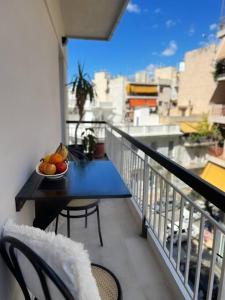 a bowl of fruit on a table on a balcony at Minimal 3BR Apartment in Athens in Athens