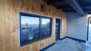 a room with a large window with a view at Ferienhaus AlpenBlick in Schöfweg