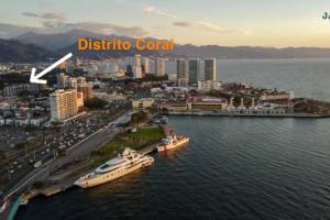 a large boat docked in the water next to a city at apartamento (de) Linda in Puerto Vallarta