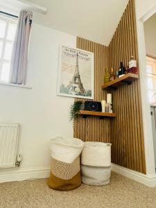 a room with two baskets and the eiffel tower at Stylish, Comfortable Coach House in Falmouth