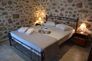 a bedroom with a bed and a table with towels at Petrino House in Margariti