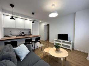 sala de estar con sofá, mesa y cocina en Tendance - Centre Montereau en Montereau-faut-Yonne