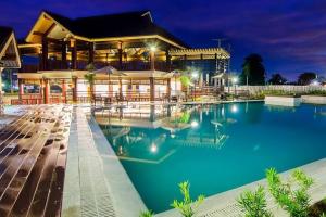 a large pool in front of a building at night at S&K One Oasis 2BR Condo Unit 2506 in Cagayan de Oro